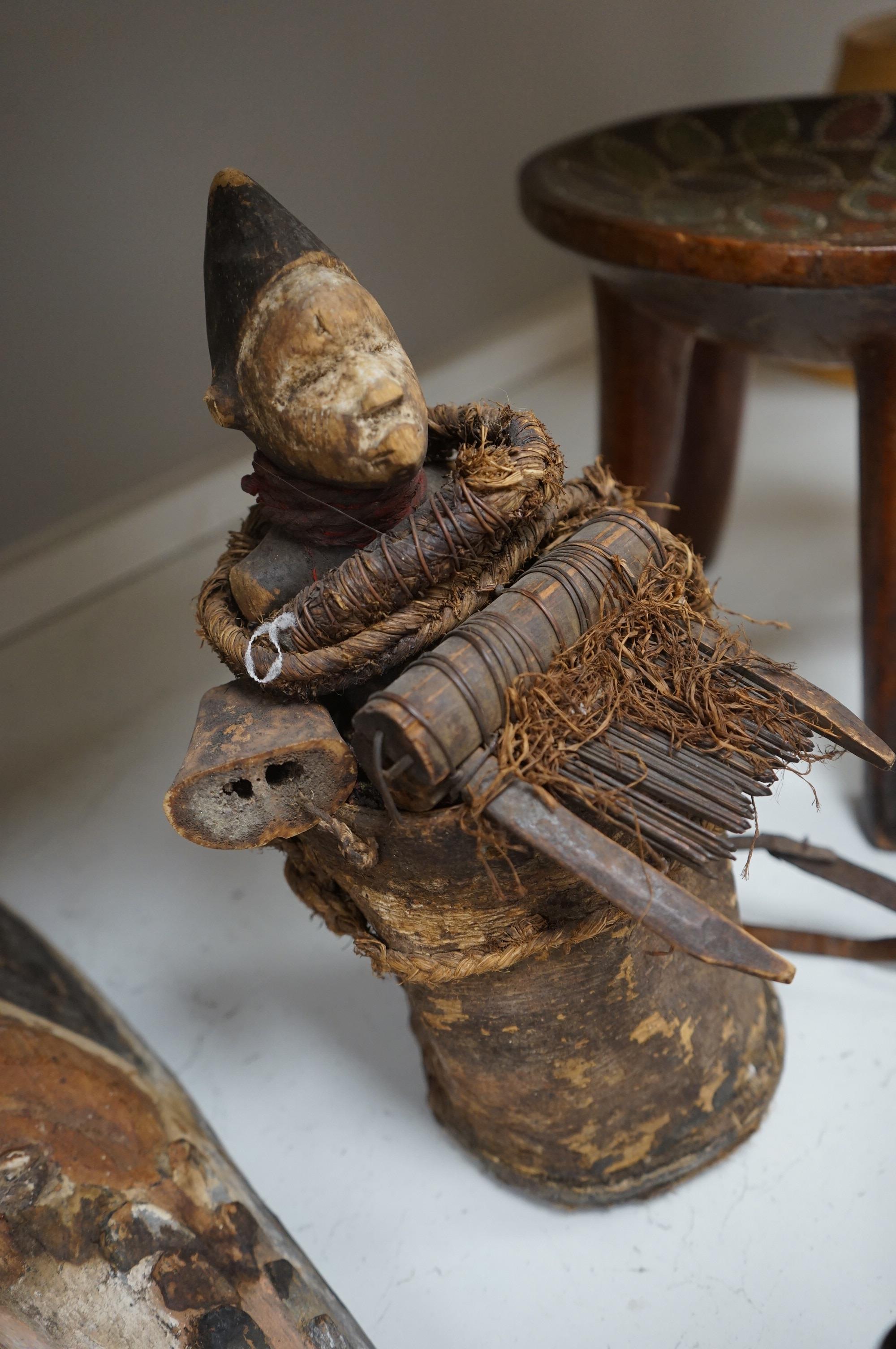 A group of African tribal artefacts, including a stool, a large painted carved mask, a carved gourd container and three carved figures, mask 76cm high. Condition- fair to good